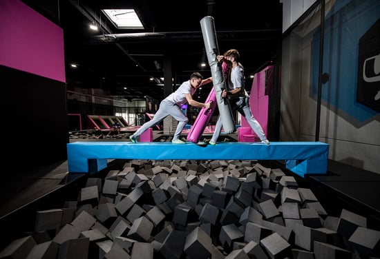 Battle beam an Trampoline park ultimate equilibrium challenge, akin to the skill of walking on a tightrope, lies ahead. - Akrobat